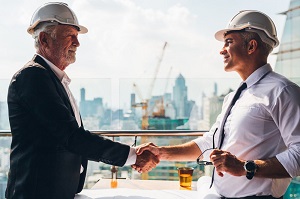 2 men in hard hats shaking hands